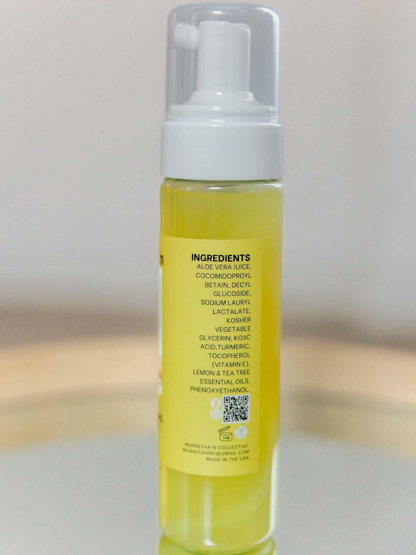 Bottle of Turmeric Foaming Face Cleanser with Kojic Acid and natural ingredients for brightening and hydrating skin
