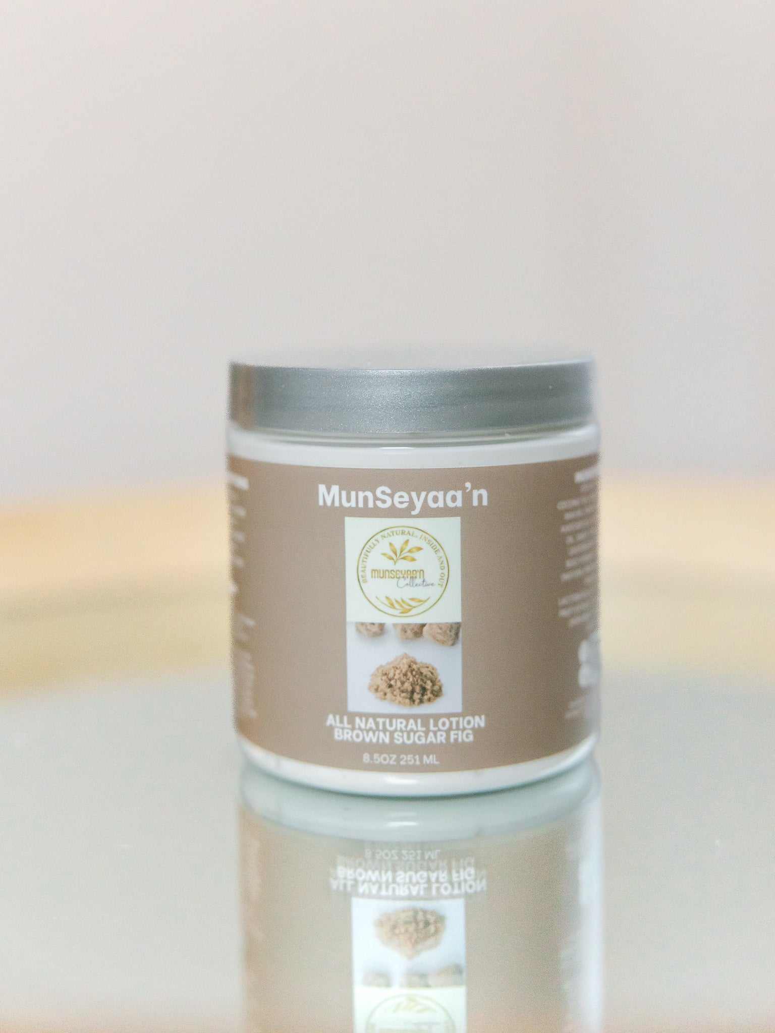 Bottle of Brown Sugar Fig Lotion with natural oils and hydrating ingredients on a white background