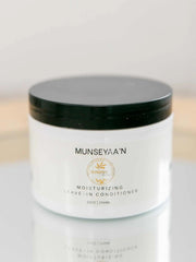 Moisturizing Leave-In Cream bottle with natural oils and shea butter for dry, damaged hair hydration and strengthening